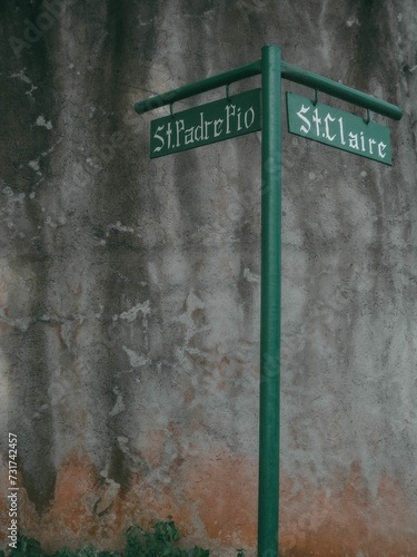 Street sign indicating that St Padre Pio and St. Claire streets are near photo