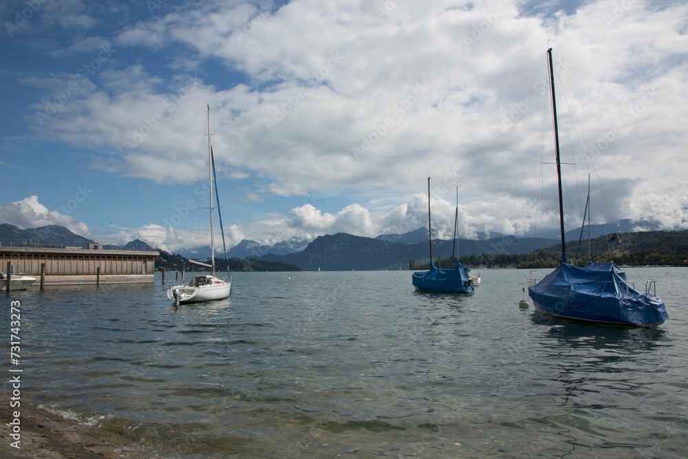 View of Lake Lucerne with moored sailboats against the background of mountains. Switzerland.