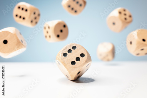 Roll the dice  throwing and rolling wooden dice on a blue background