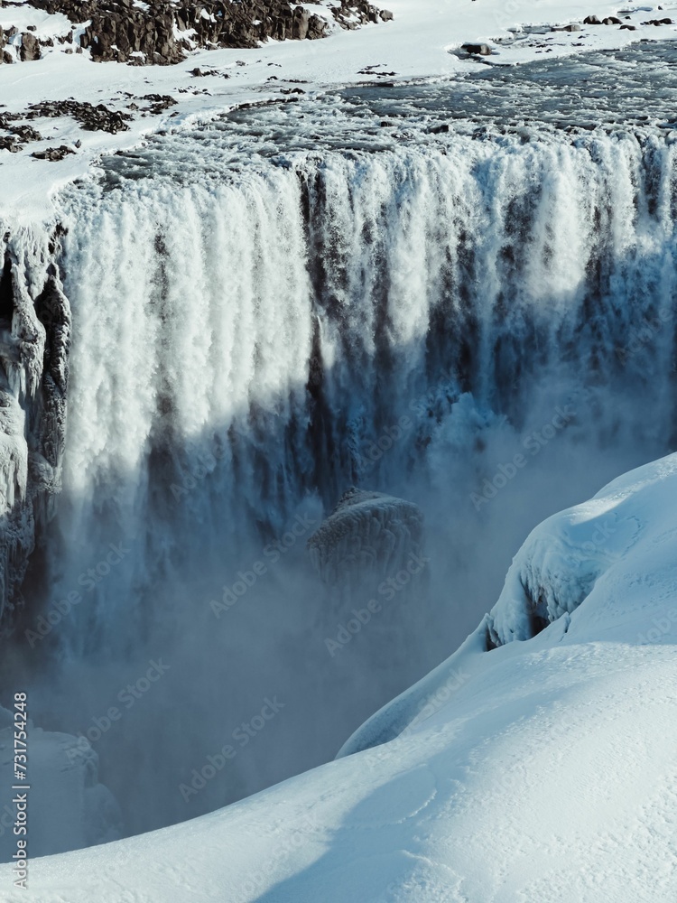 Scenic landscape shot of a majestic frozen waterfall in winter Scenic landscape shot of a majestic frozen waterfall in winter