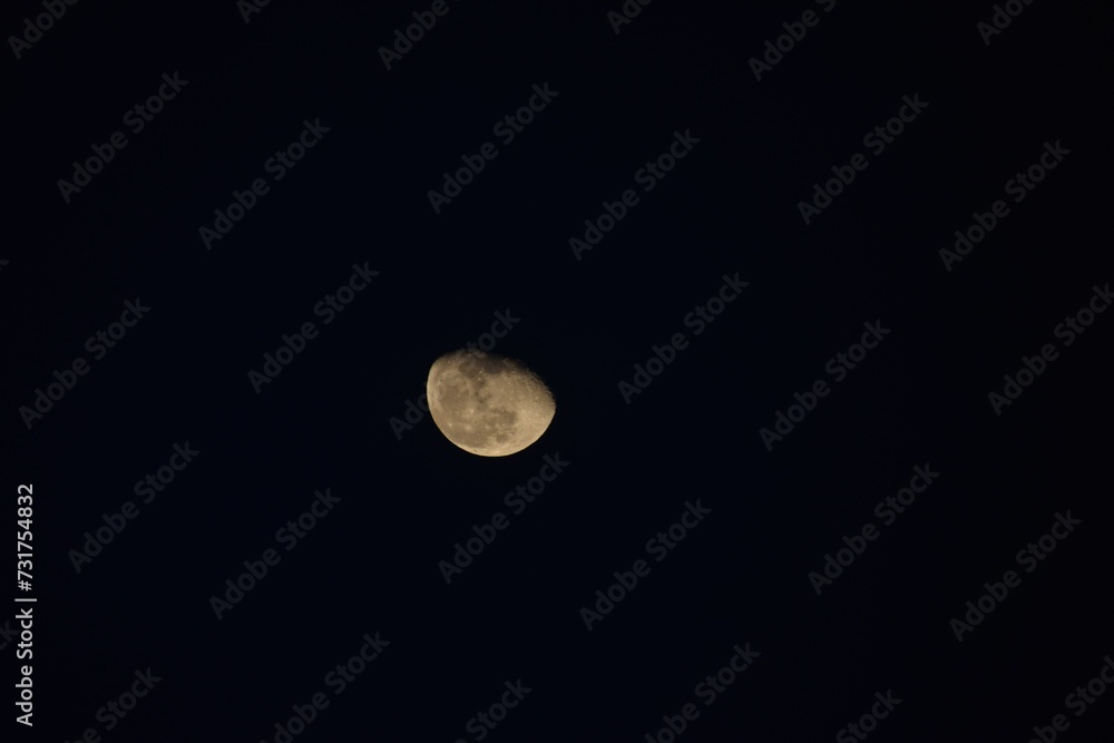 Low angle shot of the breathtaking moon covered in clouds at night Low angle shot of the breathtaking moon covered in clouds at night