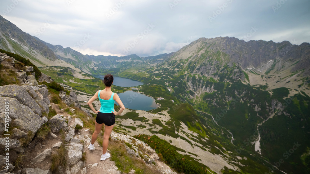 Hikers descending from Mount Rysy to Czarny Staw or Black Lake in Tatra mountains, one of the most popular alpine hiking trails in Zakopane, Poland