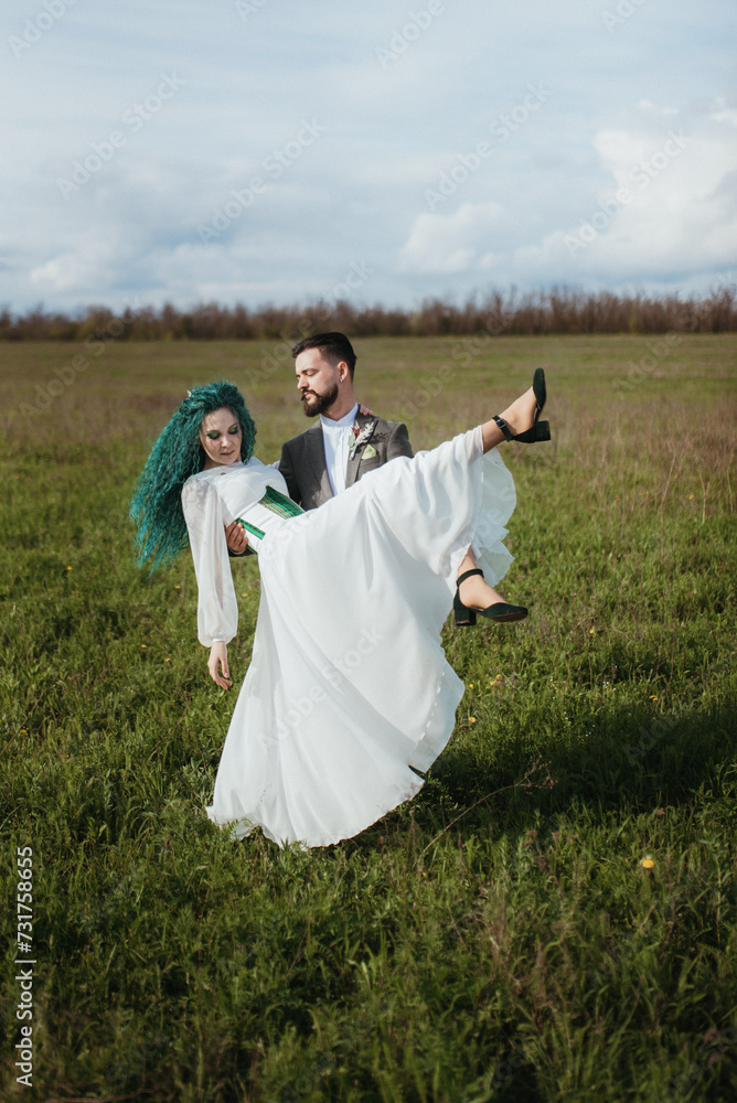 a bearded groom and a girl with green hair dance and twirl a bearded groom and a girl with green hair dance and twirl