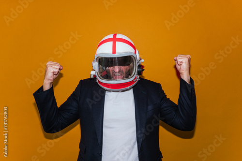 Businessman with astronaut helmet celebrating elated fists © karrastock