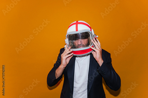Businessman with astronaut helmet looking to the side © karrastock