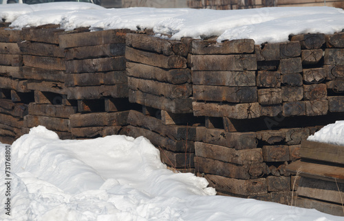 Wallpaper Mural Stacks of old vintage wooden railway sleepers surrounded by snow Torontodigital.ca