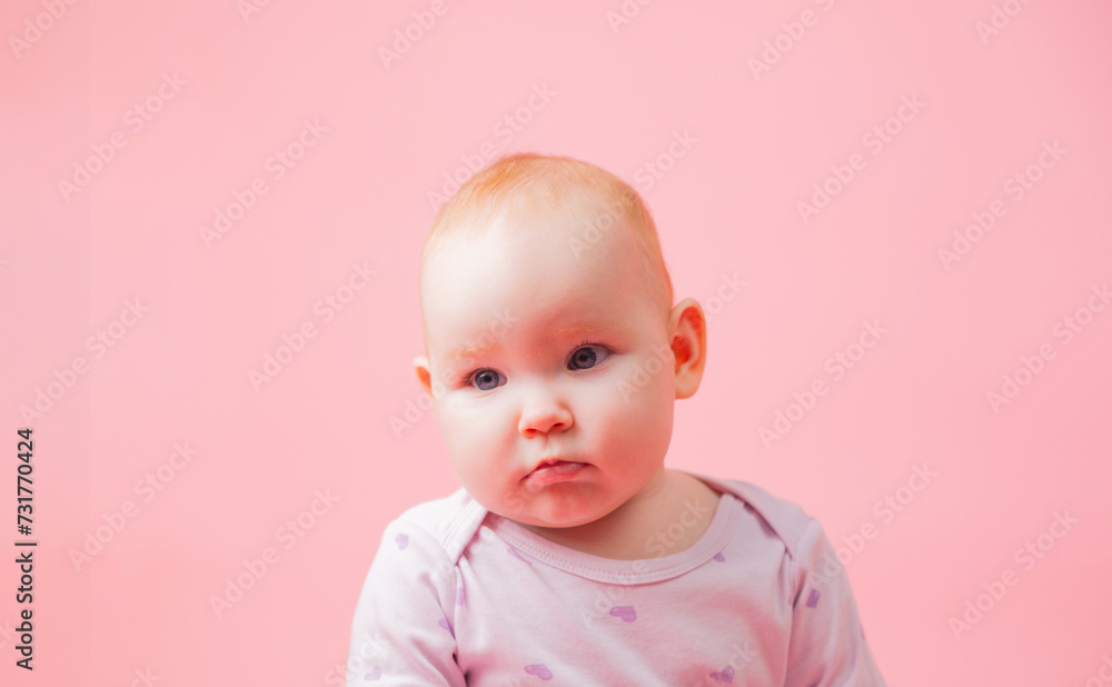 Portrait of a cute baby girl isolated on a pink background. Portrait of a cute baby girl isolated on a pink background.