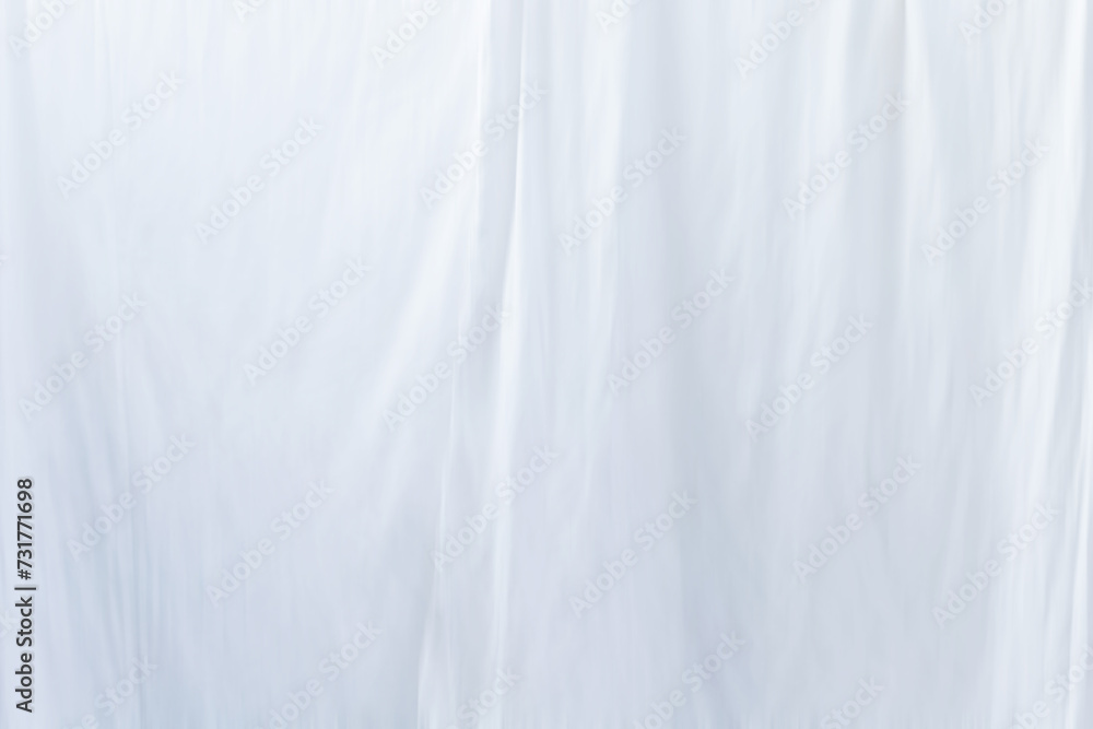 The fabric pattern is wavy white blurred abstract background The fabric pattern is wavy white blurred abstract background