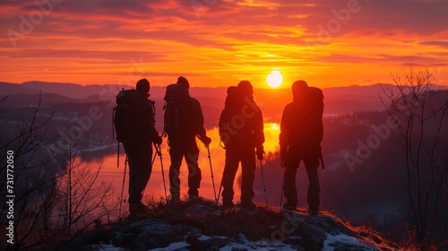 Group of people hiking on sun silhouette