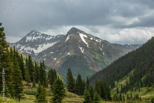 Snow capped mountains with summer storm clouds