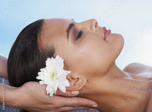 Sleeping, head massage or hands with woman or flower in spa for wellness, treatment or hospitality. Peace, relax or client with masseuse in hotel on holiday vacation for beauty therapy in a resort