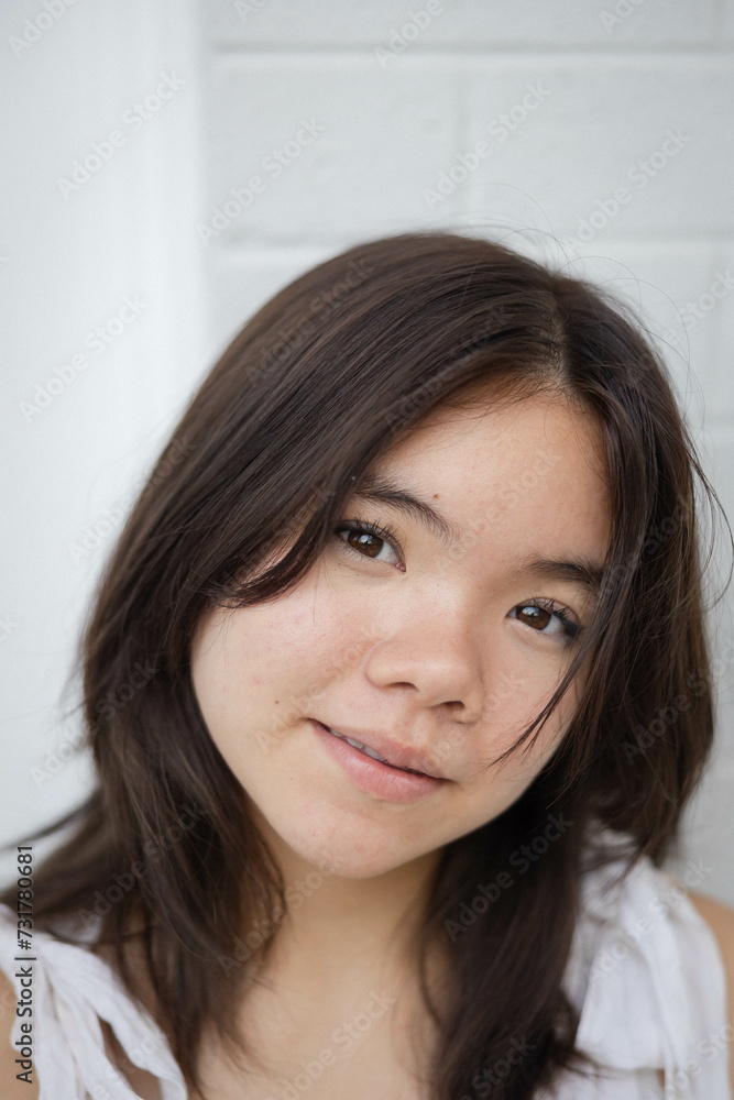Close-up portrait of teenage girl making eye contact with camera Close-up portrait of teenage girl making eye contact with camera