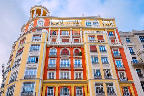 Facade of an apartment building with pastel colors in the downtown of Madrid, Spain