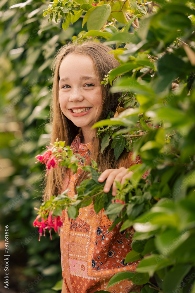 Portrait of pre-teen girl in lush garden setting Portrait of pre-teen girl in lush garden setting