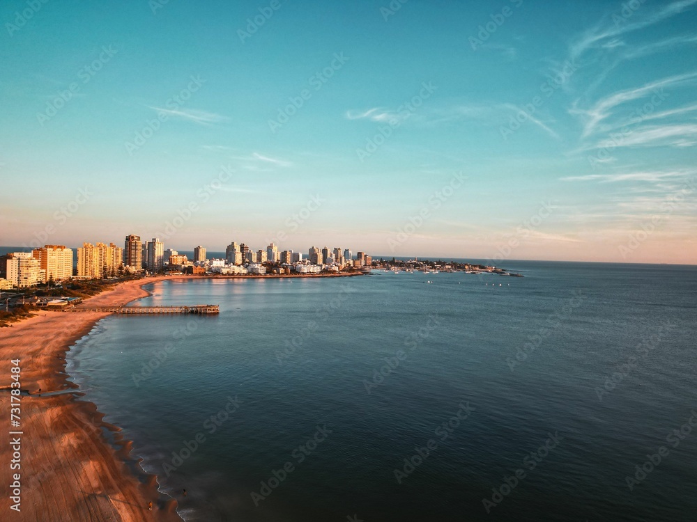 Fototapeta premium An aerial view of a beautiful sunset over Punta del Este beach
