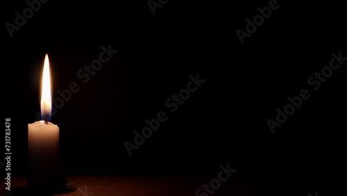 Candle flame burning on black background