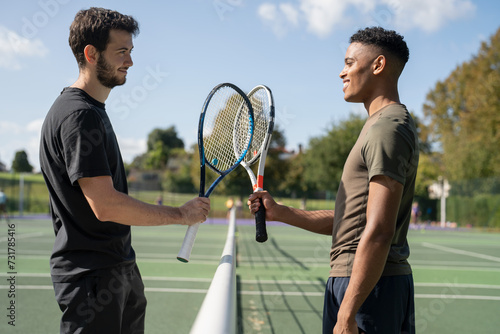 Two smiling men in tennis court © Cultura Creative