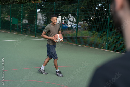 Men playing basketball outdoors