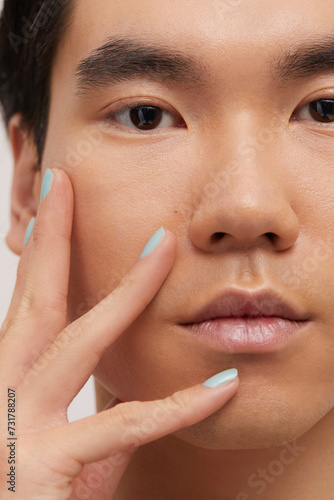 Studio portrait of handsome man with colored nails
