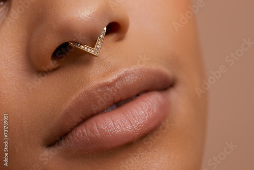Fotografie Close up portrait of non binary persons lips and pierced nose