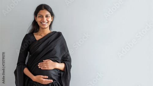 Indian pregnant woman with pregnancy belly, in soft black clothes photo