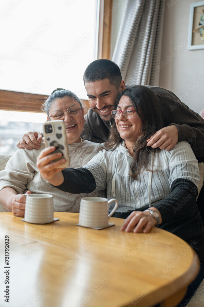 Three-generation family taking selfie at home