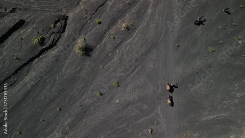 Aerial view of people walking with their horses in the volcanic field near Paricutin volcano, Mexico photo