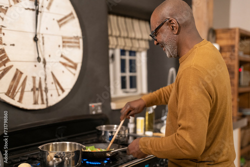 Senior man preparing food in kitchen