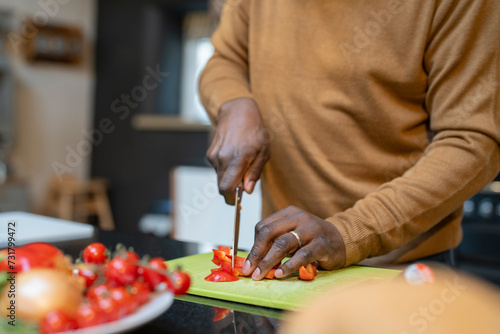 Senior man preparing meal in kitchen