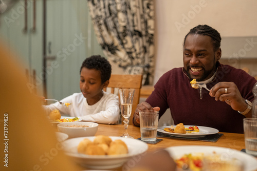 Father and son eating dinner together at home
