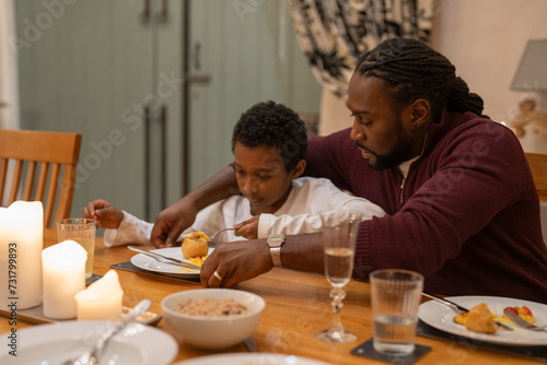 Father and son eating dinner together at home