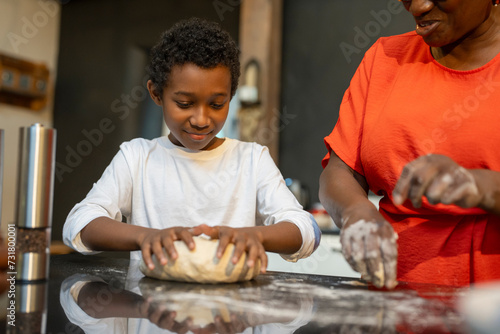 Senior woman with grandson preparing dough