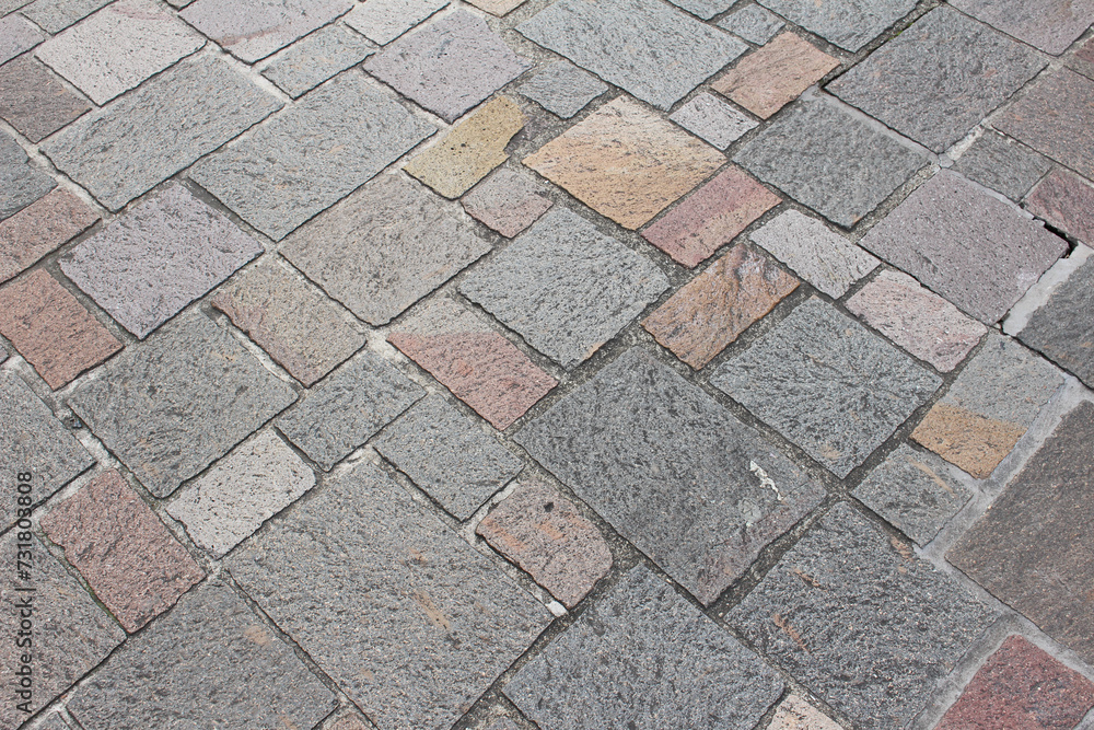 Texture of combination of different size square cobblestones. Pattern of sidewalk tiles in the street. Square cobblestones close up. Texture of combination of different size square cobblestones. Pattern of sidewalk tiles in the street. Square cobblestones close up.