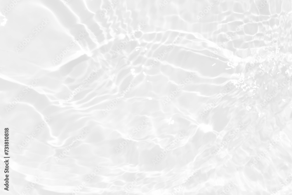 Obraz premium White water with ripples on the surface. Defocus blurred transparent white colored clear calm water surface texture with splashes and bubbles. Water waves with shining pattern texture background.