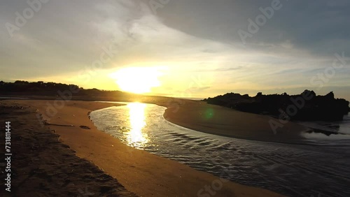 Time lapse video of the beautiful view of the sunrise on the beach with small waves, morning natural panorama on Karang Paranje beach, Garut photo