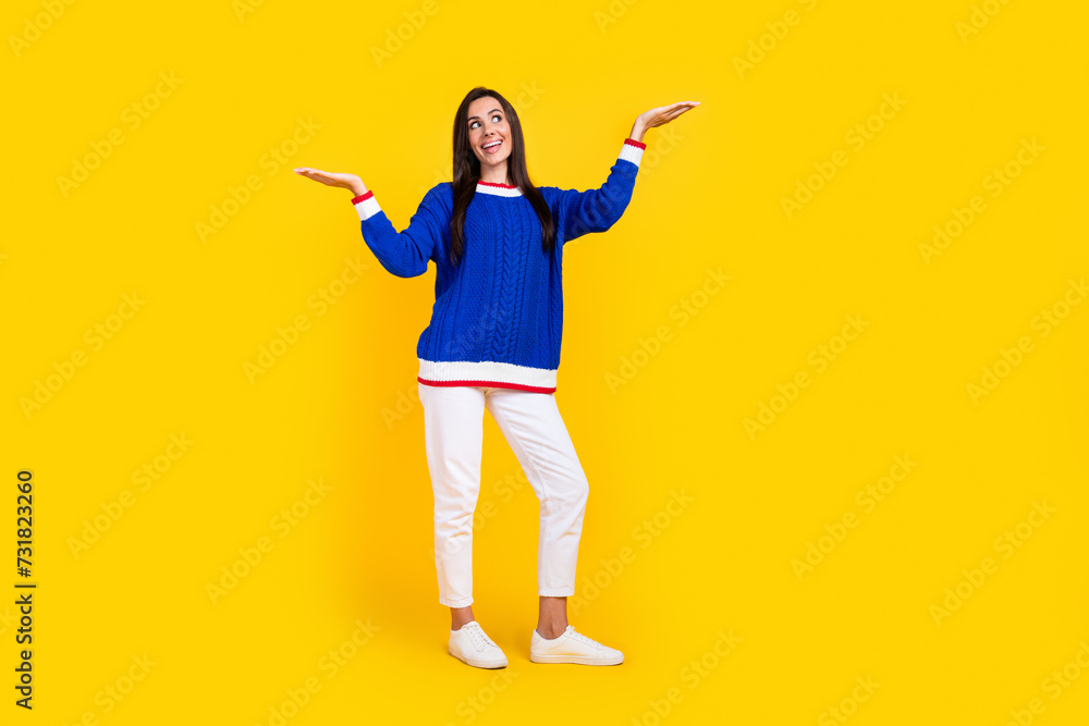 Full length photo of hispanic promoter girl in blue stylish jumper compare advantage language courses isolated on yellow color background Full length photo of hispanic promoter girl in blue stylish jumper compare advantage language courses isolated on yellow color background