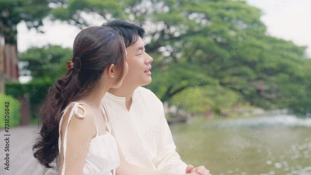 Young adult asia people man woman sit easy enjoy nature view at hotel outdoor looking away outside. Happy relax lover flirt care trust sweet comfort asian love tender smile on warm time date day. Young adult asia people man woman sit easy enjoy nature view at hotel outdoor looking away outside. Happy relax lover flirt care trust sweet comfort asian love tender smile on warm time date day.