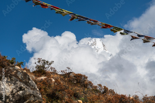View of Ama Dablam mountain in clouds during trekking in Nepal. EBC Everest Base Camp or Three passes trek in Nepal. Mountain range Himalayas in Pangboche village, the Khumbu region of Nepal, Asia.