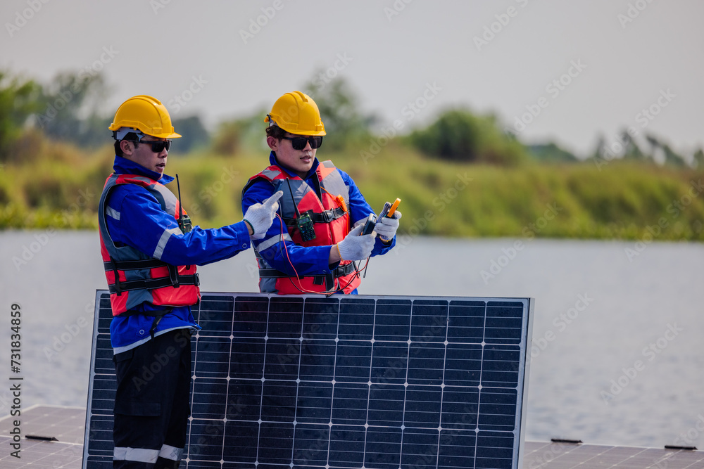 Technicians check floating solar farm wiring, polarity, and grounding for reliability and safety Technicians check floating solar farm wiring, polarity, and grounding for reliability and safety