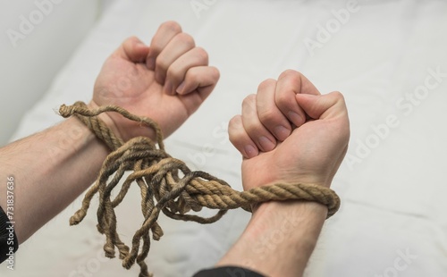 a close up of a persons hands tied up with rope