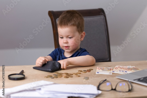The boy takes out cents from a small purse, a euro for counting savings. The child learns financial literacy. Education and finance concept. High quality photo