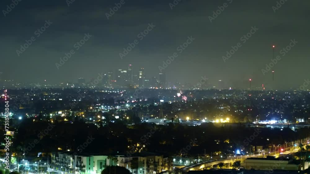 Aerial Forward Shot Of Fireworks Exploding In Modern City Against Sky At Night - Los Angeles, California Aerial Forward Shot Of Fireworks Exploding In Modern City Against Sky At Night - Los Angeles, California