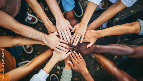 A heartwarming photograph capturing a group of individuals from diverse backgrounds joining hands in unity photo