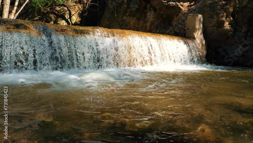 Waterfalls in the forest with rocks and tree branches. Small waterfalls in a mountain top. Sunny day with glorious nature. Forest river. Eaton Canyon Natural Area Park, Pasadena. 4k photo