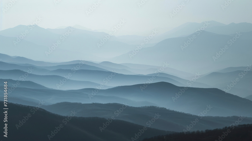 In the distance the mountains are ly visible through the mist giving a sense of depth and vastness to the landscape.