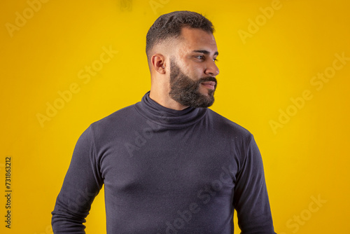 Man with beard wearing black shirt, with various facial expressions