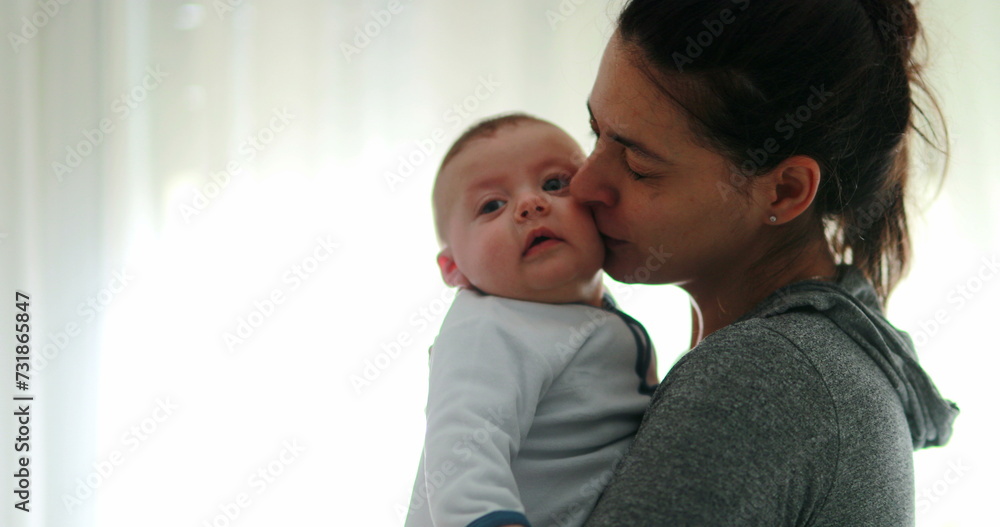 Mom consoling baby infant in causal candid authentic moment Mom consoling baby infant in causal candid authentic moment