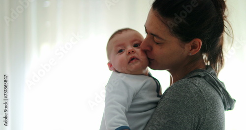 Mom consoling baby infant in causal candid authentic moment