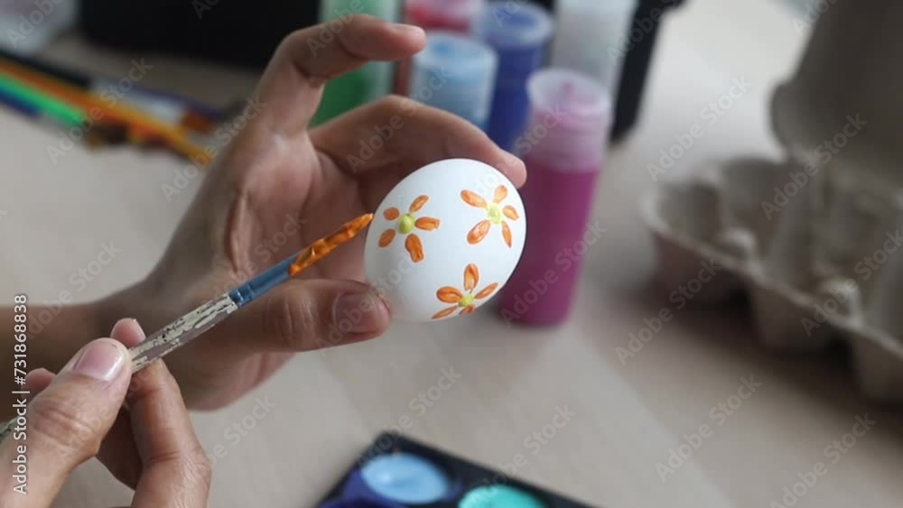 hands of a dark-skinned Latina artisan woman, painting Easter eggs with brushes and acrylic paints hands of a dark-skinned Latina artisan woman, painting Easter eggs with brushes and acrylic paints