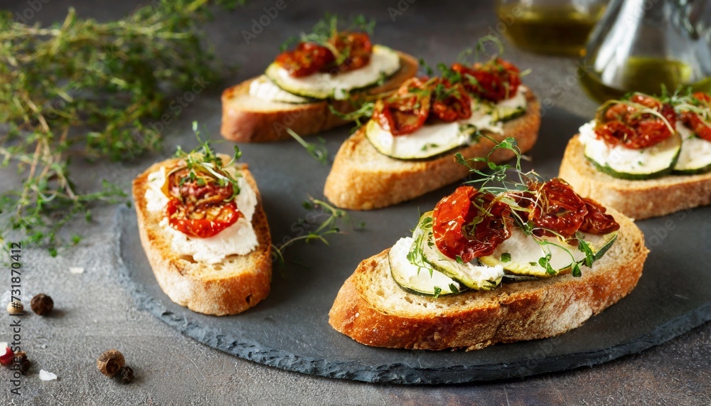 Italian bruschetta bread with cream cheese, zucchini and dried tomato with herbs. Canape with ricotta cheese Italian bruschetta bread with cream cheese, zucchini and dried tomato with herbs. Canape with ricotta cheese